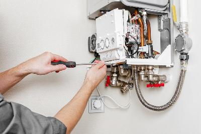 Electrician in Heating Engineer and Farnborough Fixing a boiler